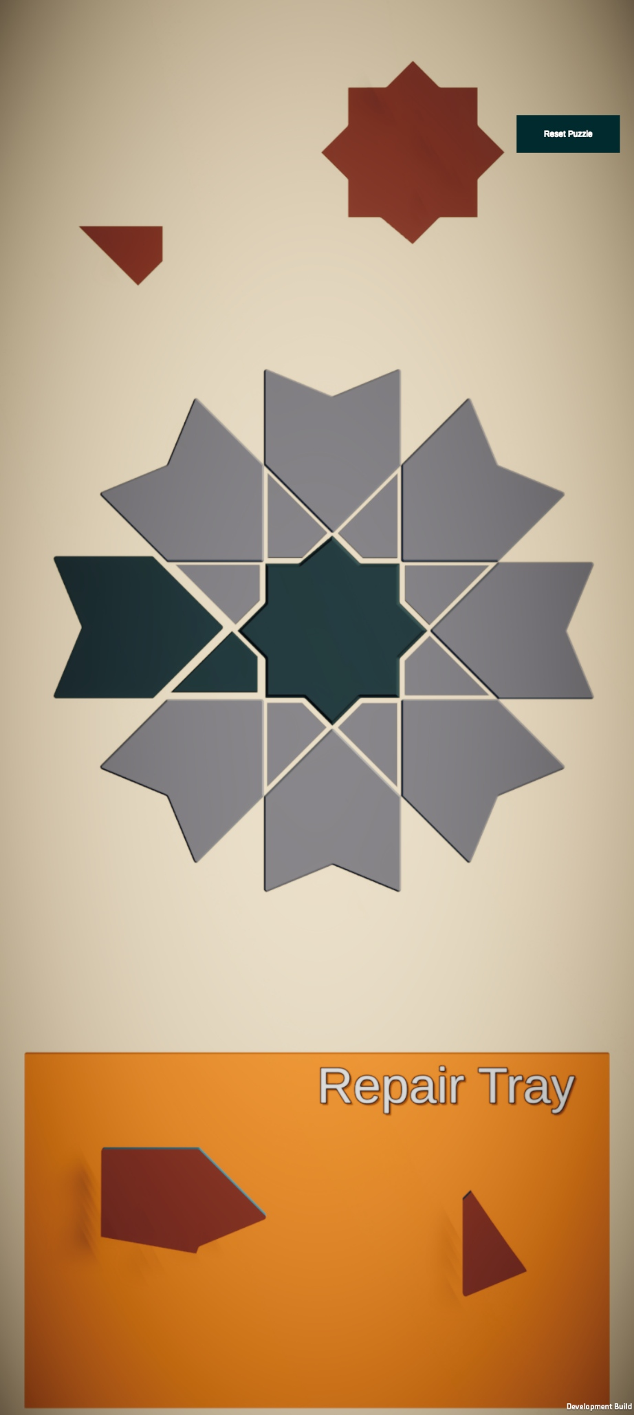 Early Pieces of Home Unity prototype with a star-centered mosaic, loose tiles, and an orange repair tray containing fragments.